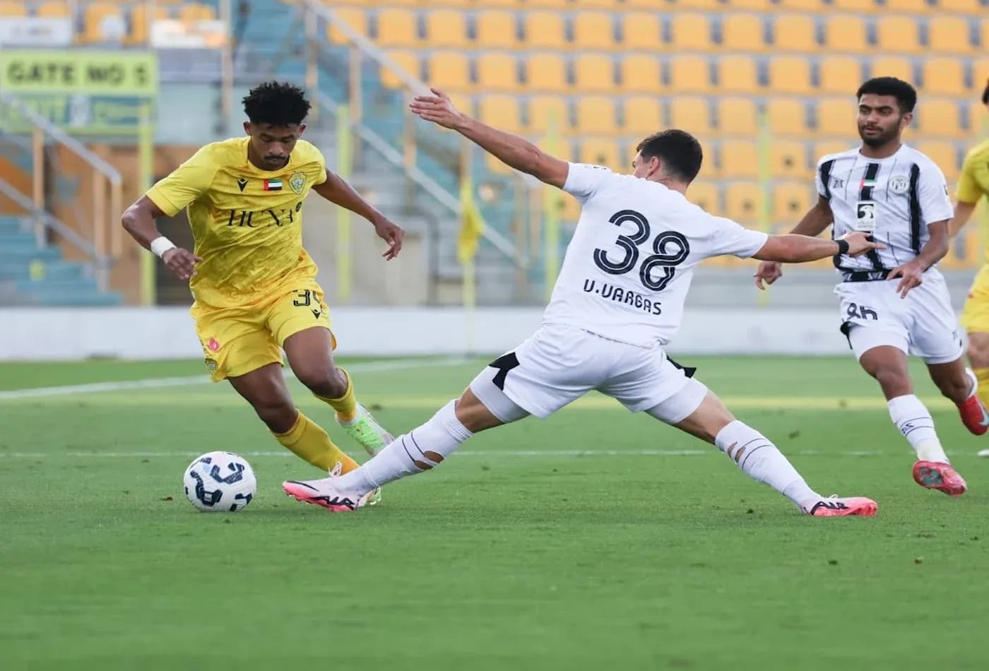 Al Wasl U23 player dribbling past Al Jazira U23 defender