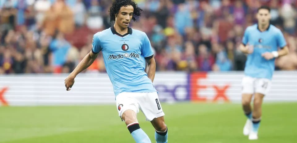 Player in blue kit passing the ball during match