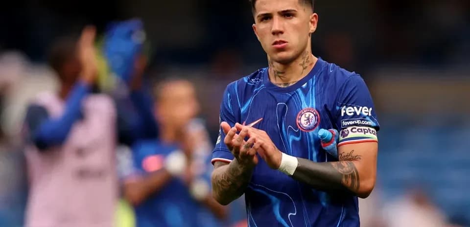 Player in Chelsea jersey clapping after match