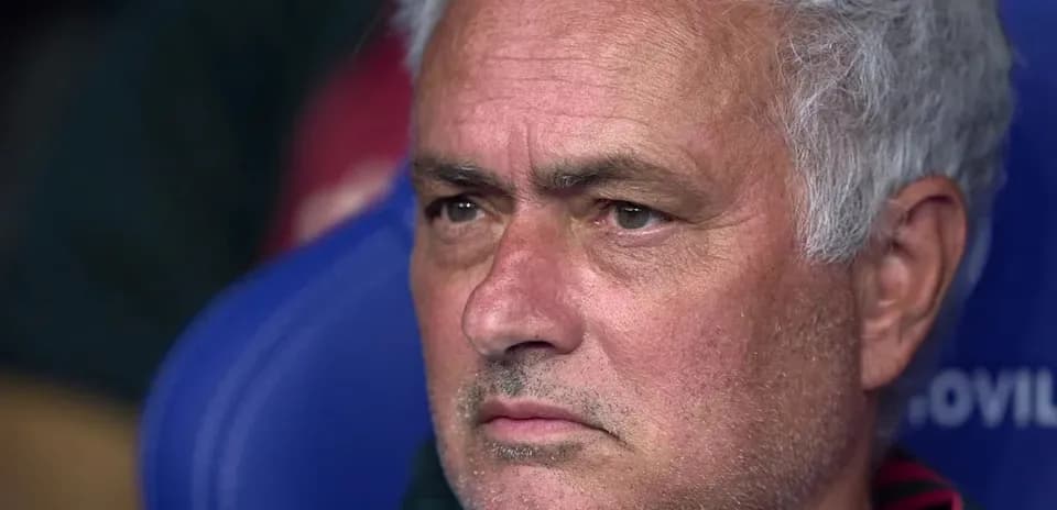 Manager sitting on the bench during match