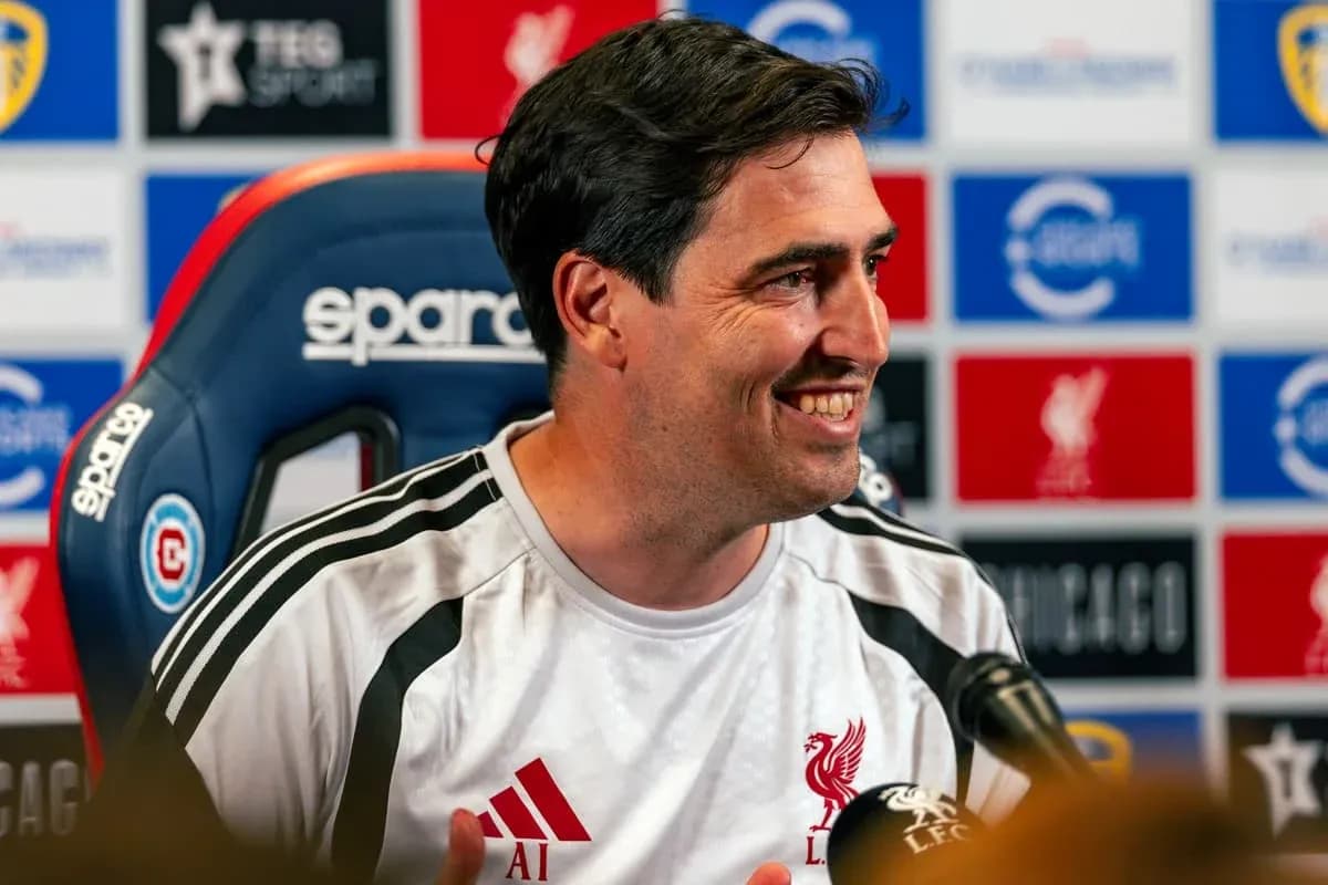 Manager speaking at press conference with Liverpool branding