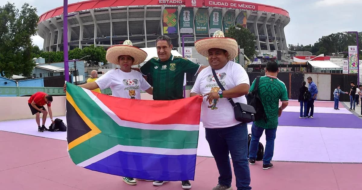 Fans holding South African flag outside stadium
