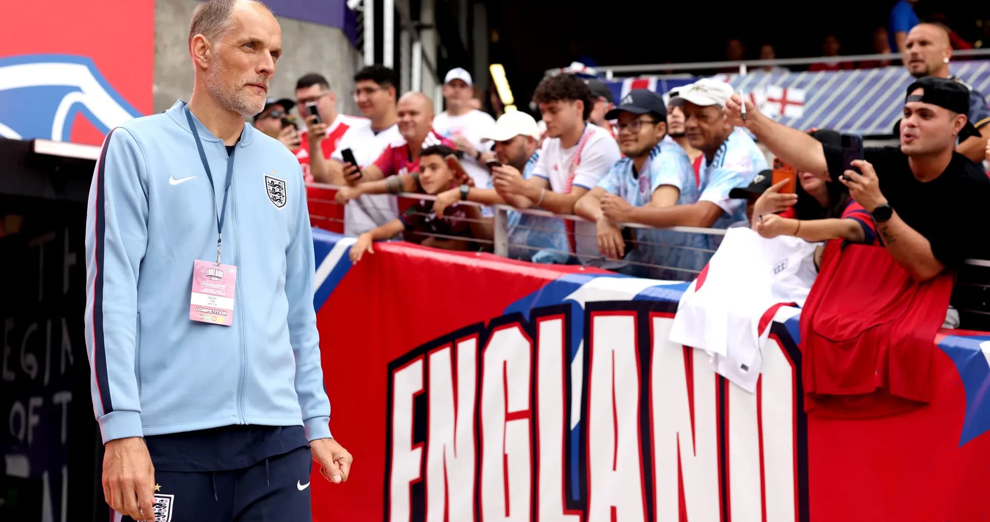 Coach walking towards fans before match in stadium