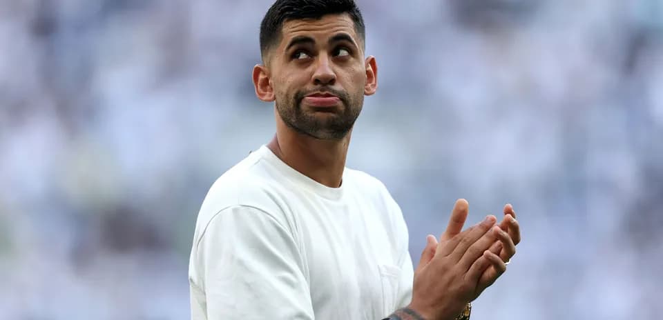 Player clapping and looking up at crowd