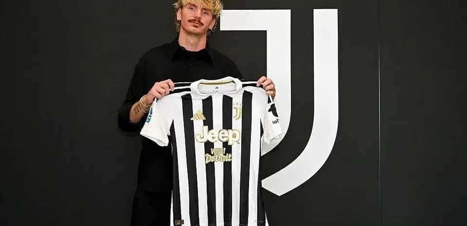 Player holding Juventus jersey at presentation event