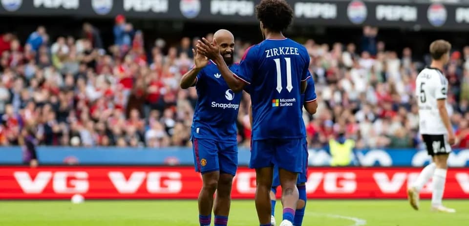Players celebrating during a match with fans in background