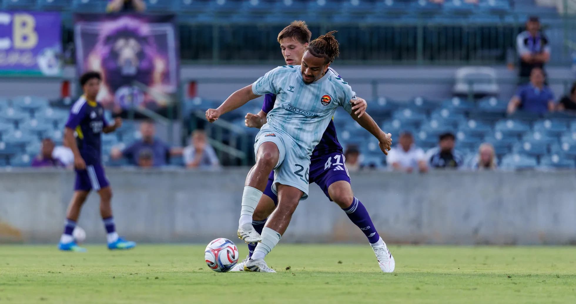 Player tackling opponent during Orlando City II match