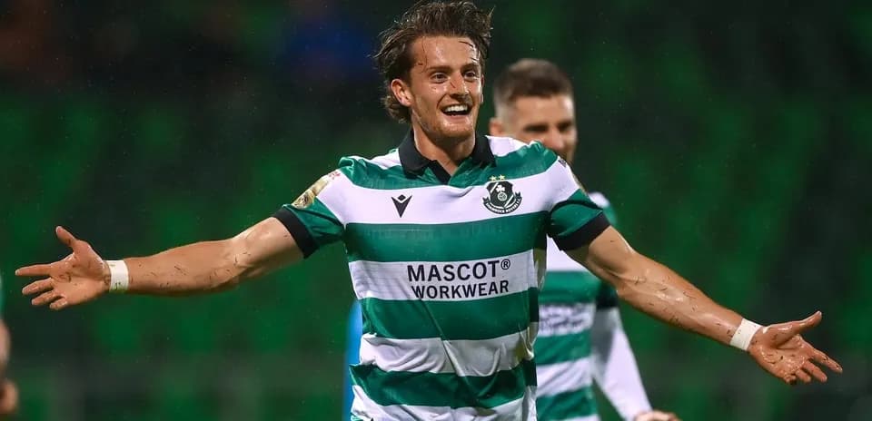 Player celebrating a goal in green striped jersey