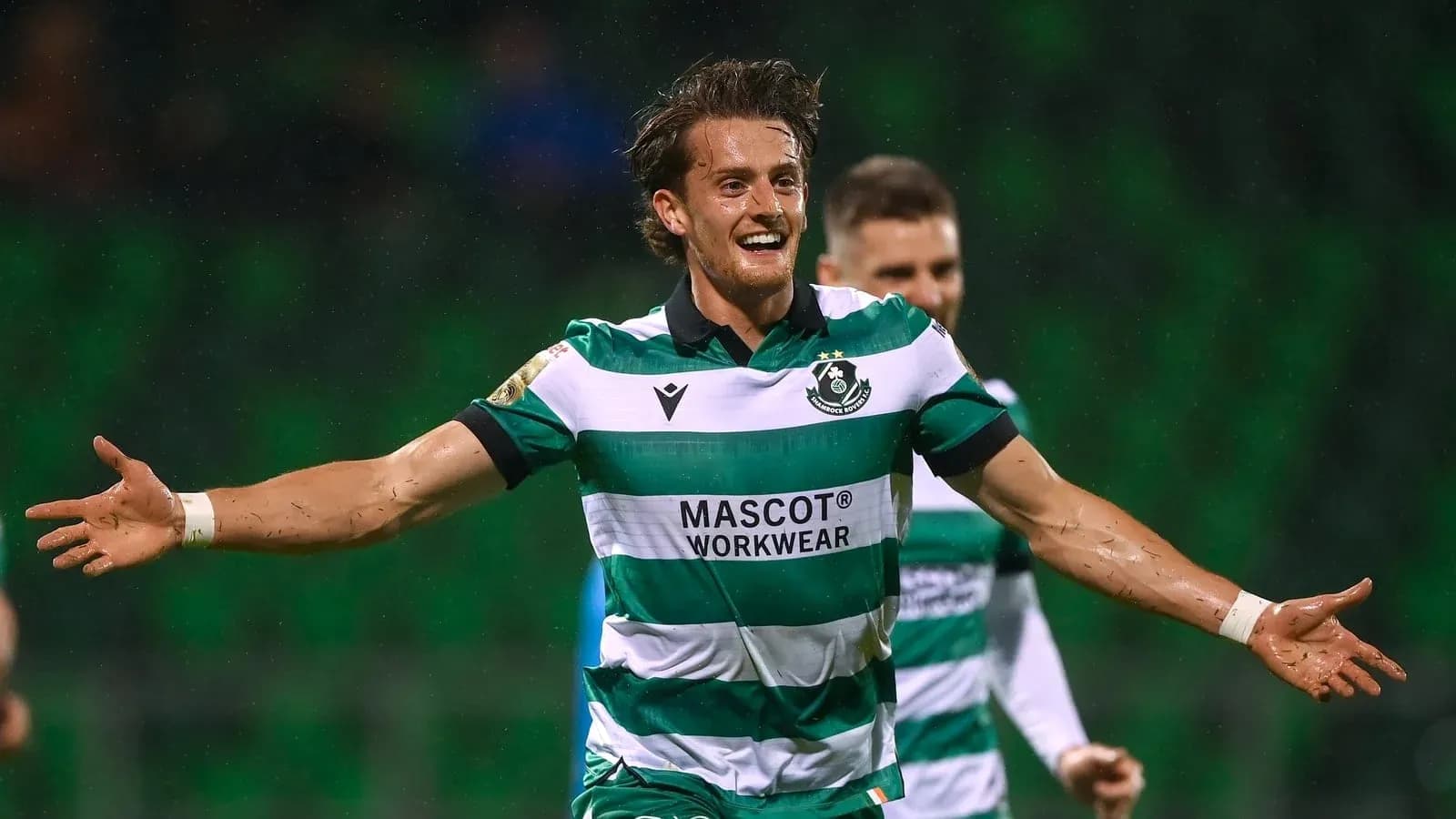 Player celebrating a goal in green striped jersey