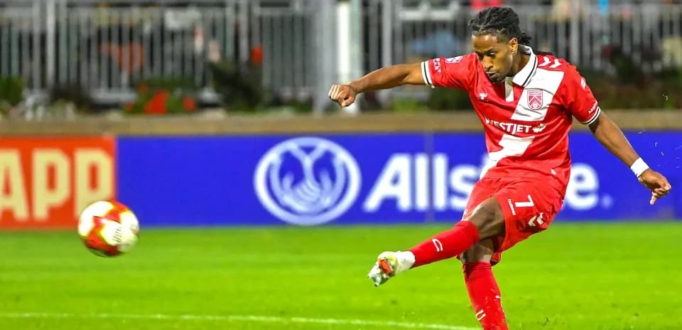 Player striking the ball during Cavalry FC match
