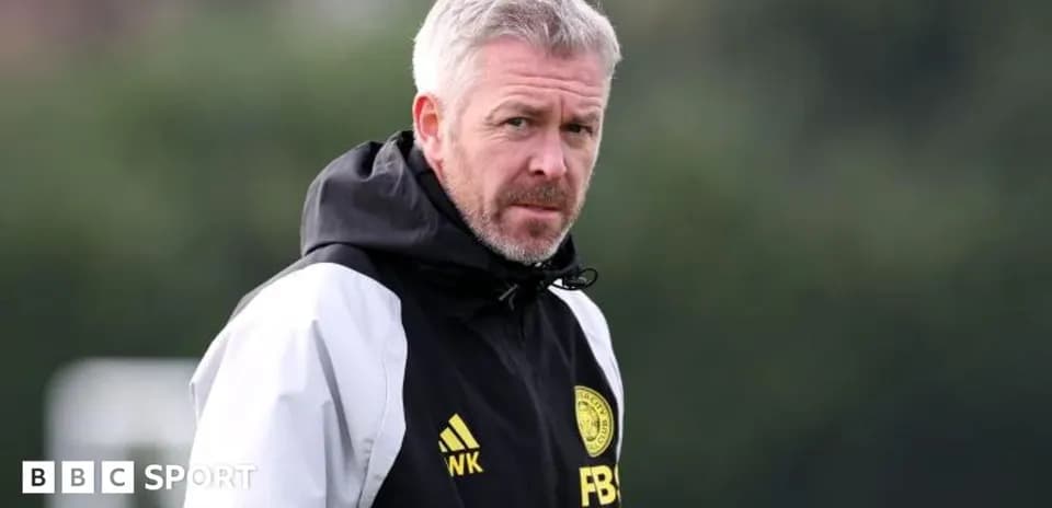 Coach observing players during training session