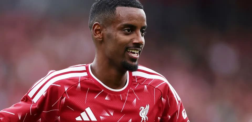 Player in red Liverpool kit smiling during match