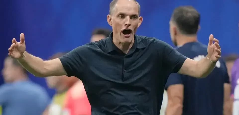 Coach gesturing animatedly during match on sidelines