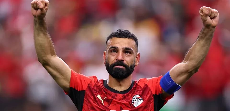 Player celebrating with raised fists in team jersey