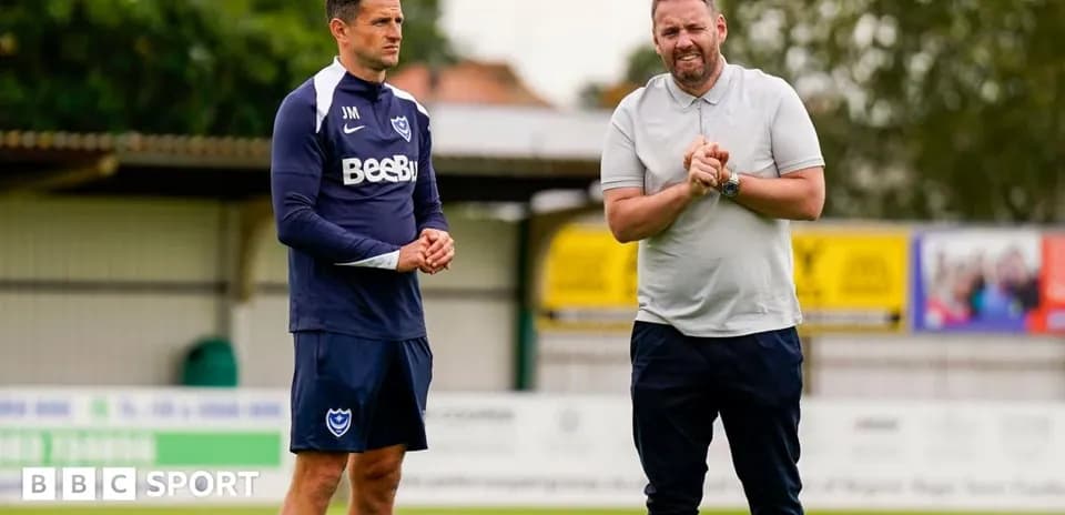 Two men discussing on a football training pitch