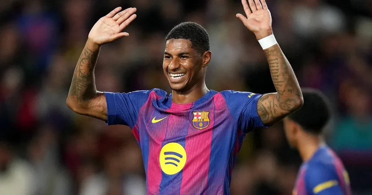Player celebrating with hands raised on pitch
