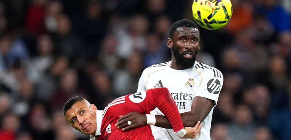 Real Madrid player challenging Sevilla opponent