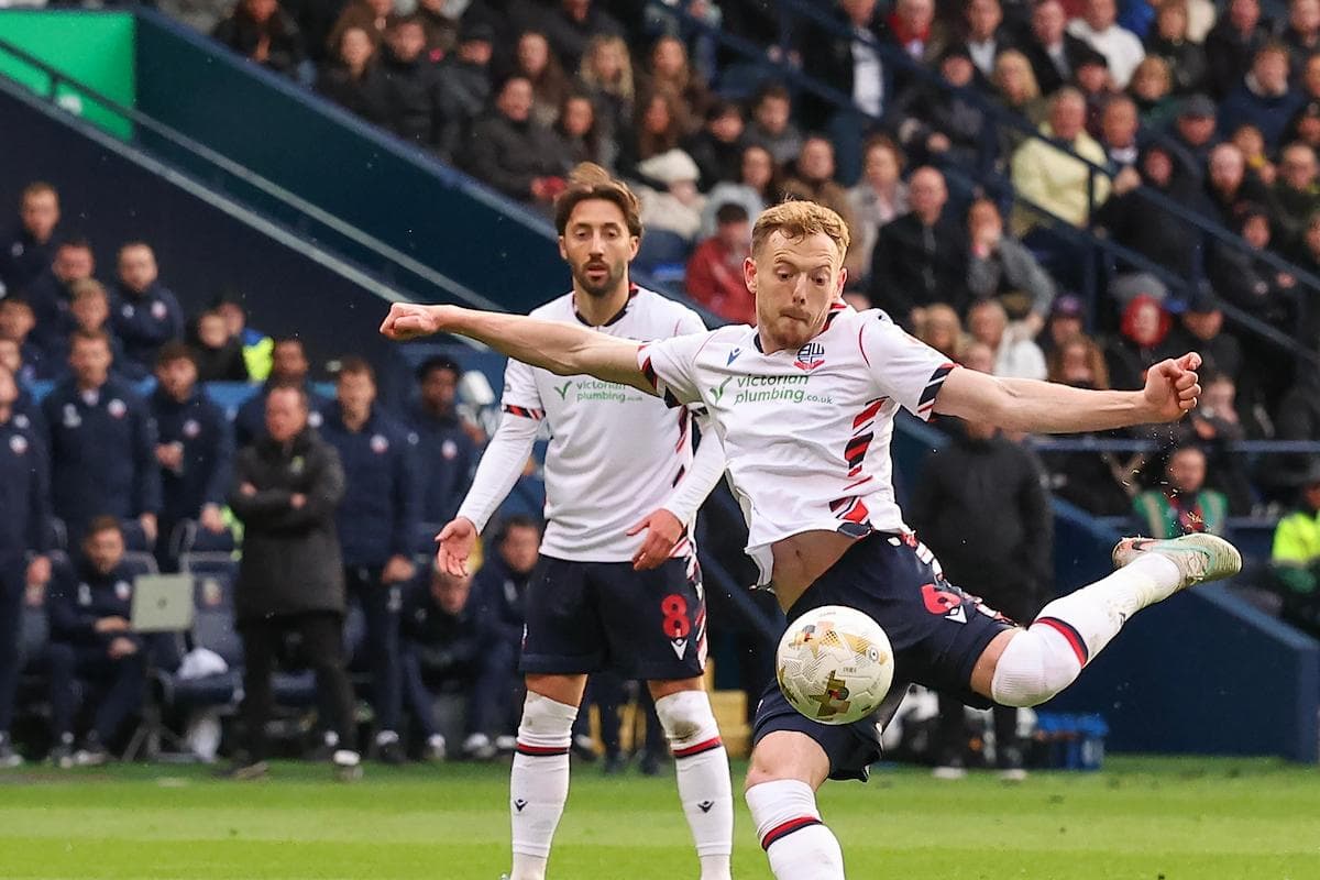 Player striking the ball during a football match