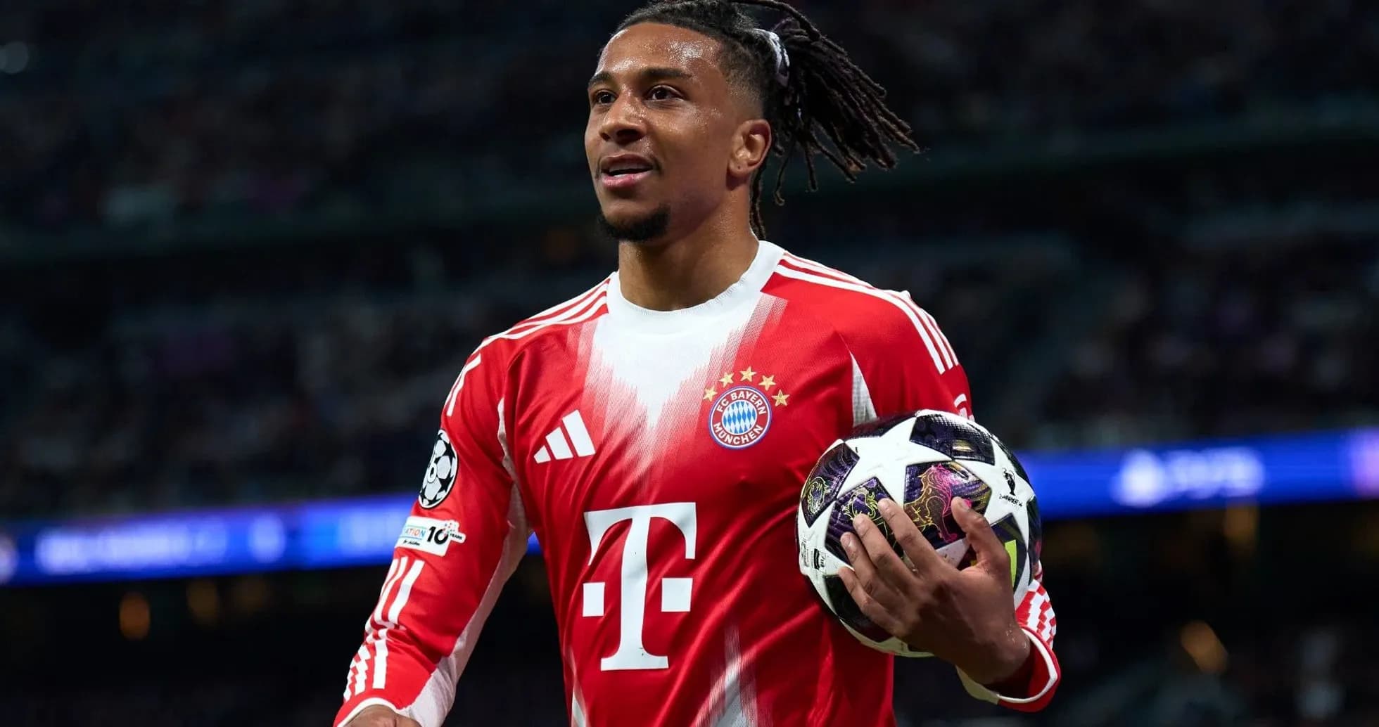 Player holding a Champions League ball on pitch