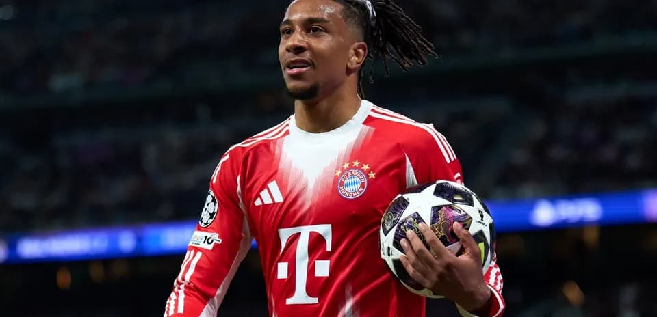 Player holding a Champions League ball on pitch
