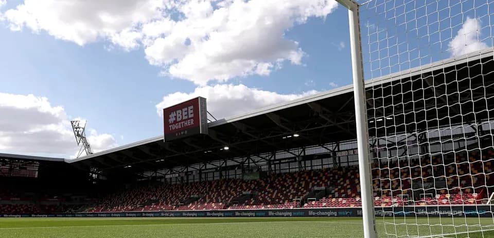 View of goalpost and stadium under cloudy sky