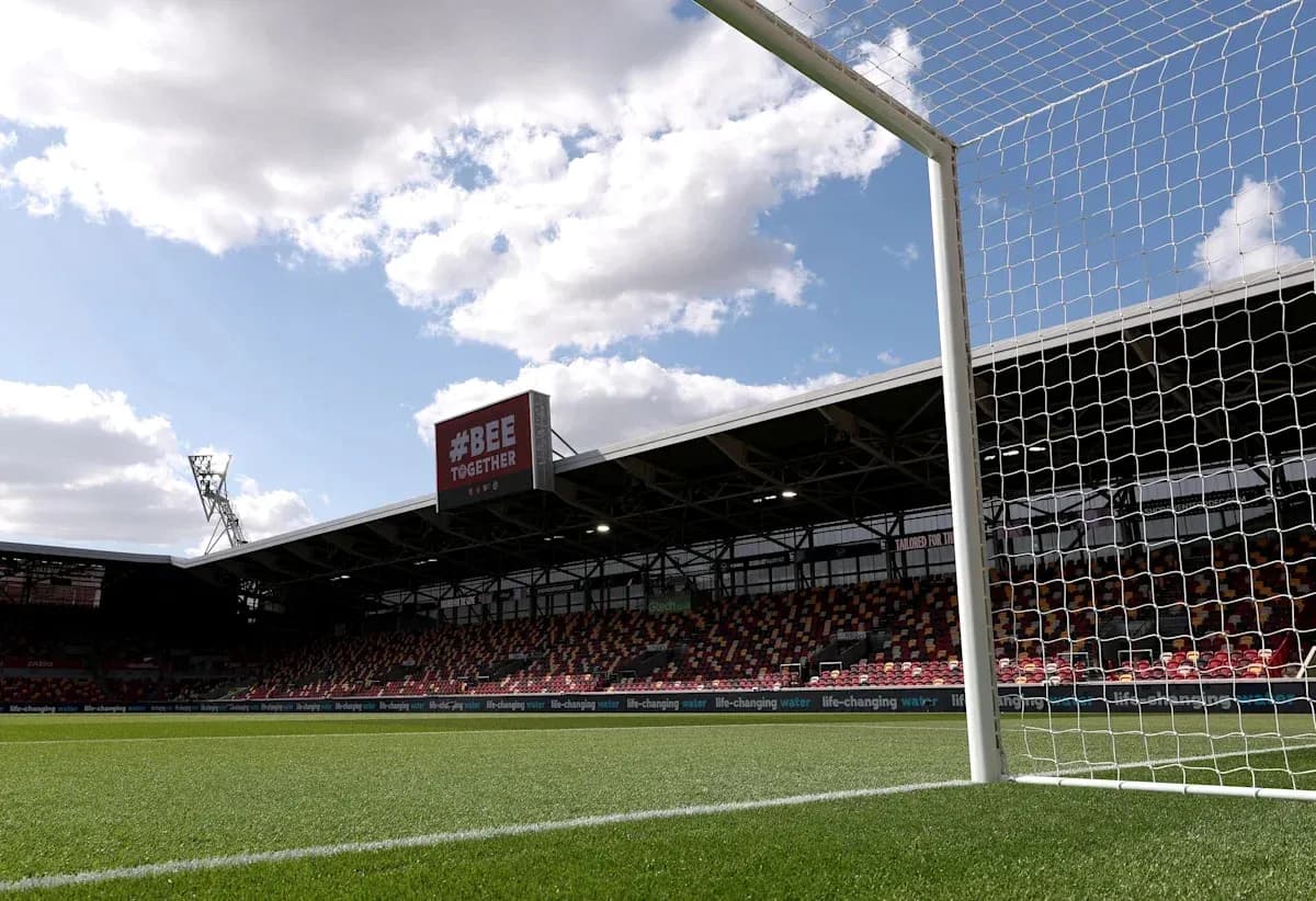 View of goalpost and stadium under cloudy sky