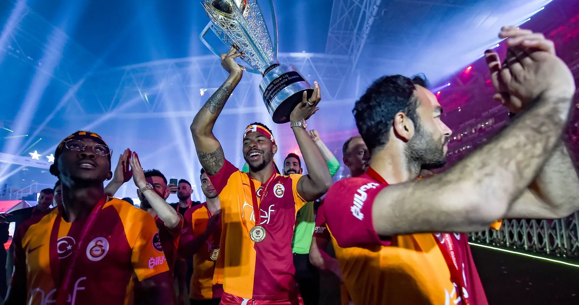 Player celebrating with trophy during victory parade