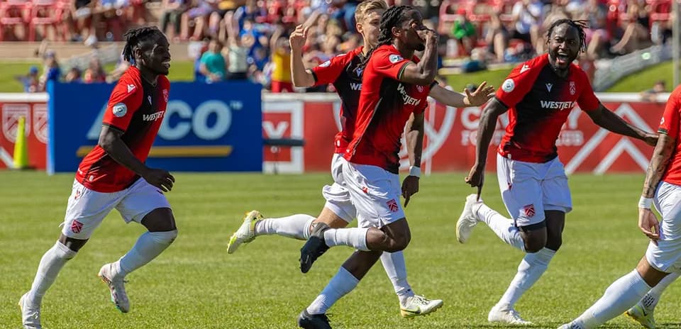 Players celebrating a goal during match