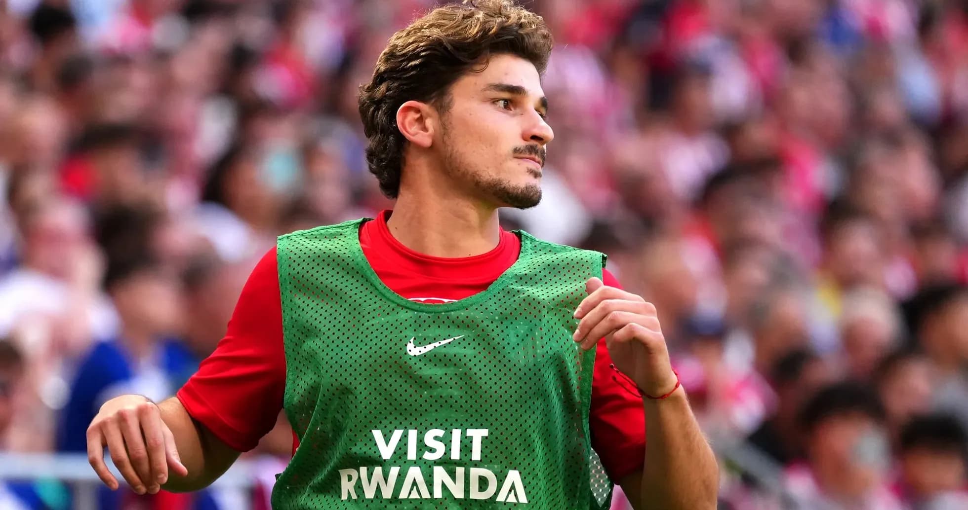 Player in warm-up jersey on the sidelines