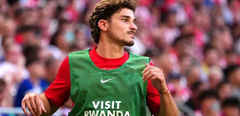 Player in warm-up jersey on the sidelines