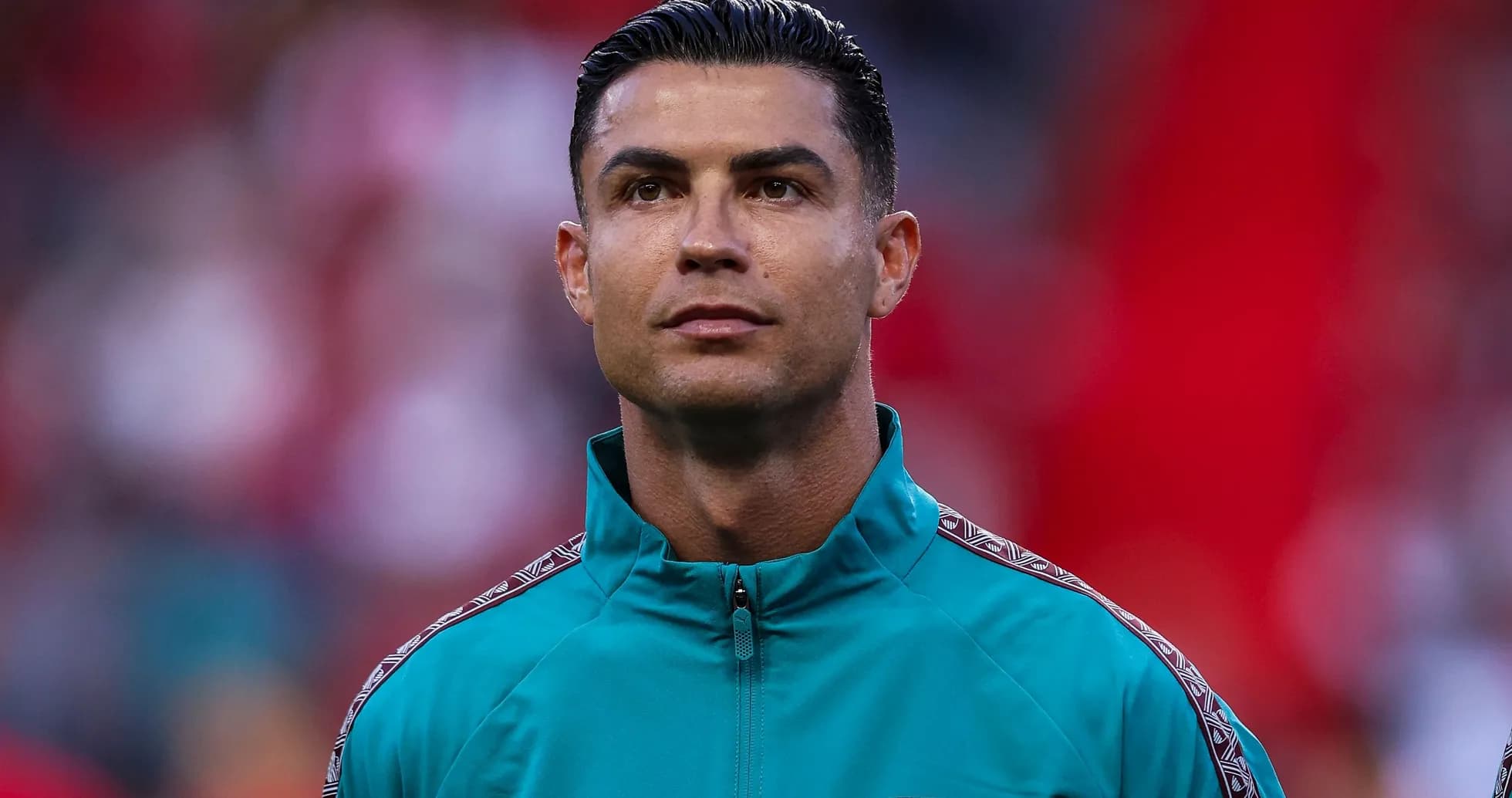 Player wearing teal jacket before match