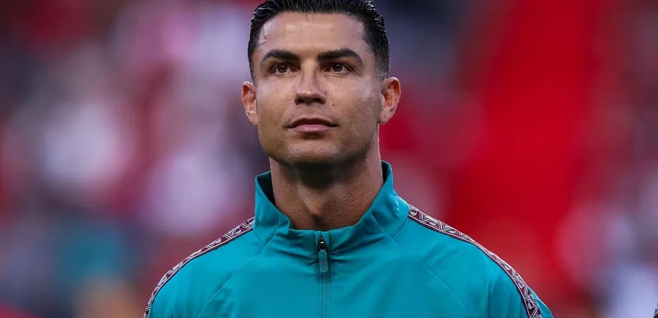 Player wearing teal jacket before match