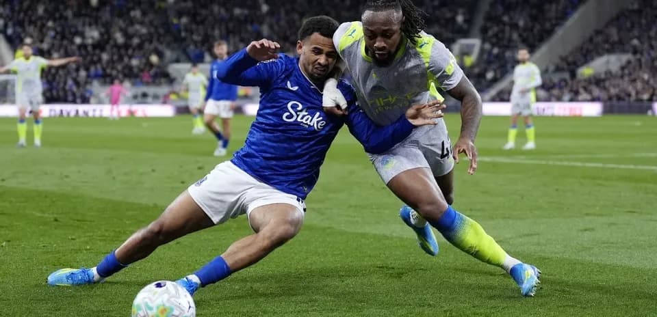 Two players battling for possession on the field