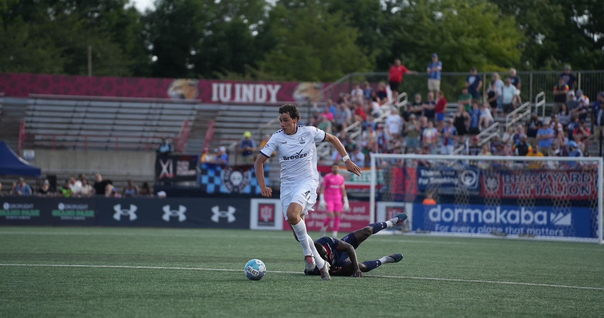 Player dribbling past opponent during USL match