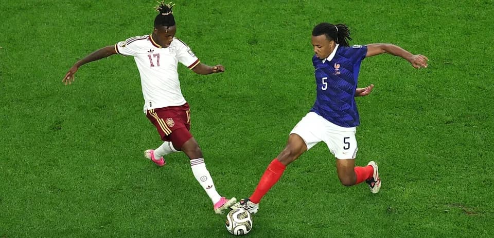 Two players challenging for the ball during match