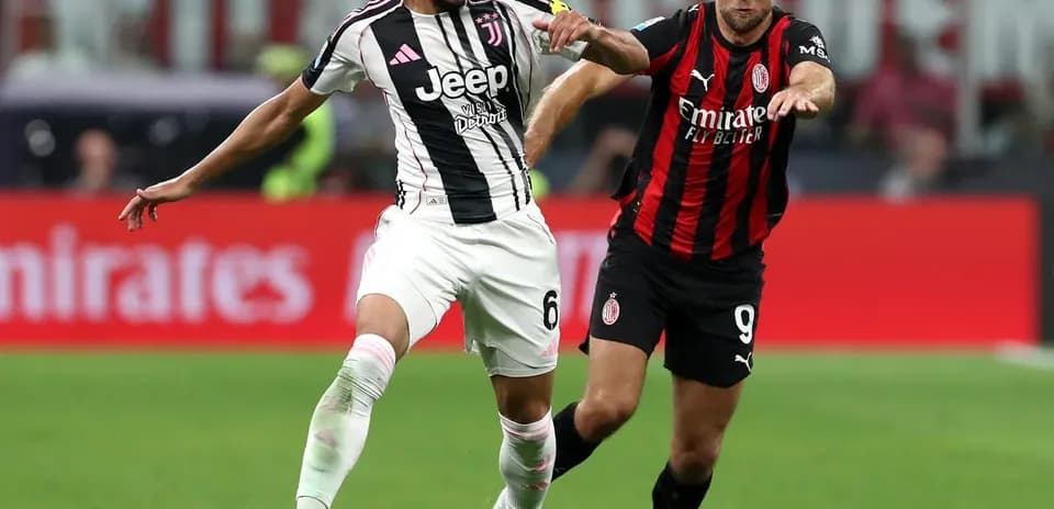 Juventus player competing against AC Milan player