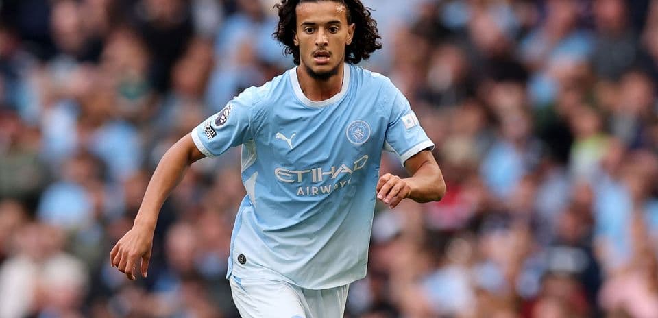 Player running with the ball in Manchester City kit