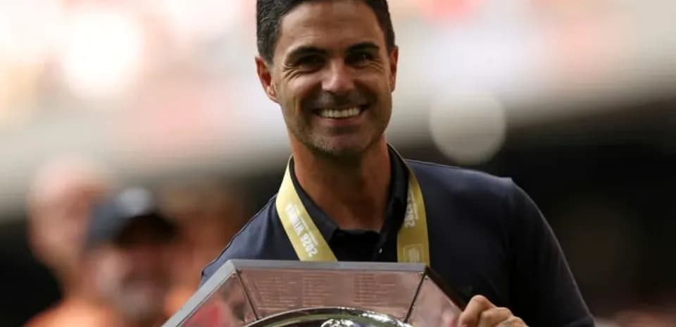 Coach holding trophy during celebration ceremony