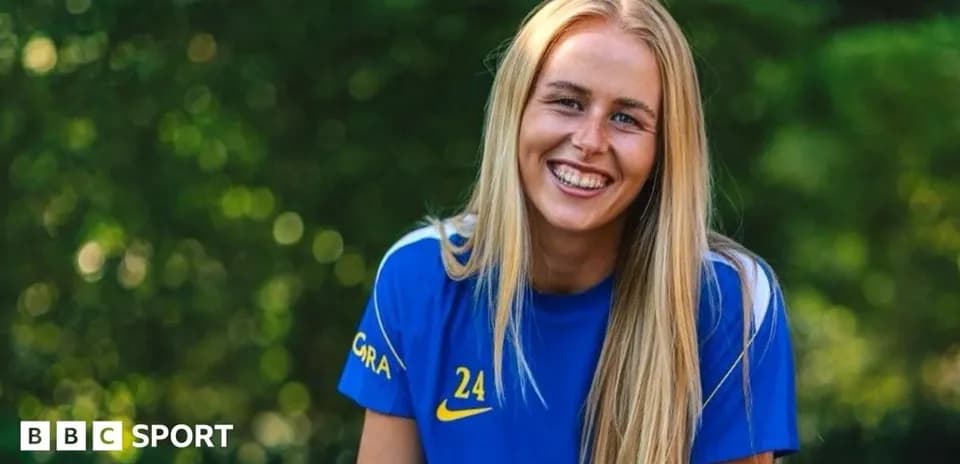 Smiling athlete wearing blue jersey outdoors
