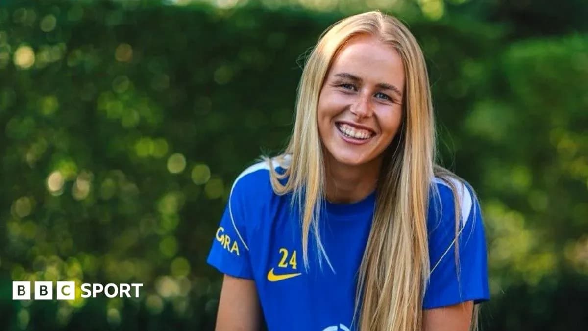 Smiling athlete wearing blue jersey outdoors