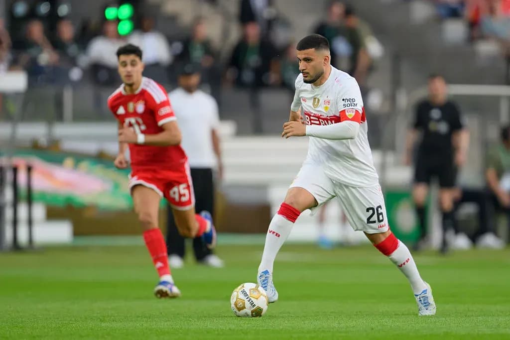 Player in white dribbling the ball during match