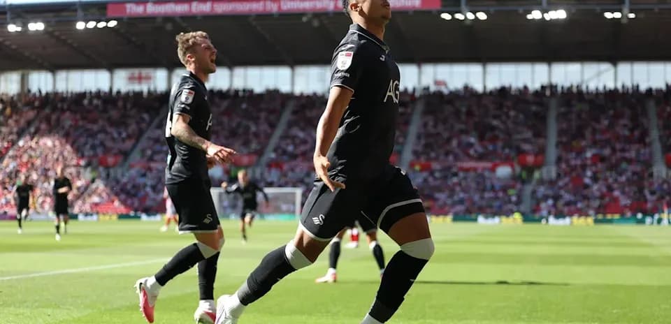 Swansea City player celebrating a goal on field