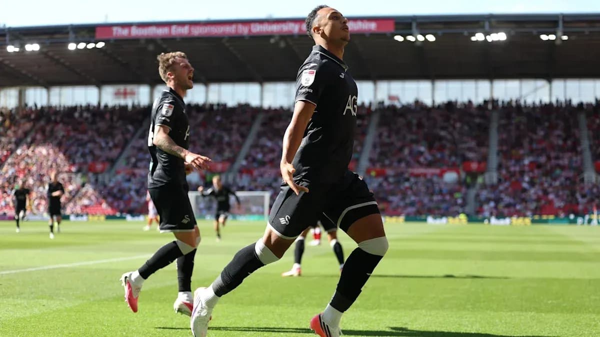 Swansea City player celebrating a goal on field