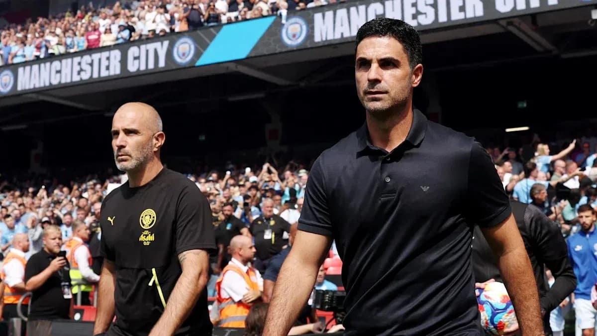 Two football managers walking towards the pitch