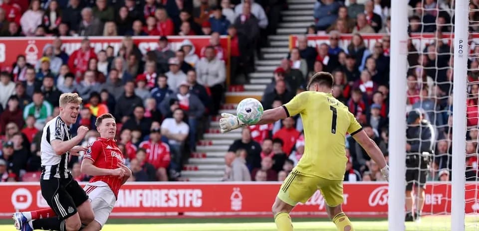Goalkeeper saving a shot during Nottingham Forest match