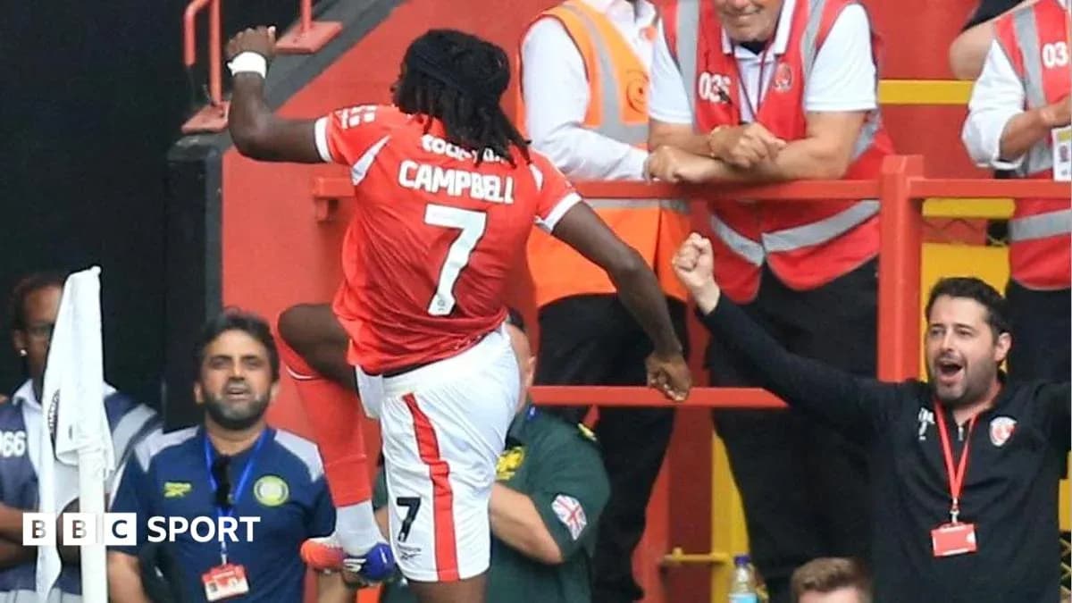 Player celebrating goal with fans in stadium
