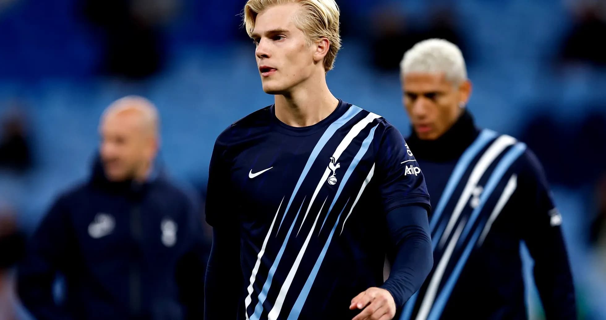 Player walking on pitch before match with teammates