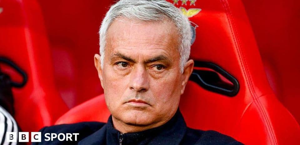 Manager sitting on bench during match