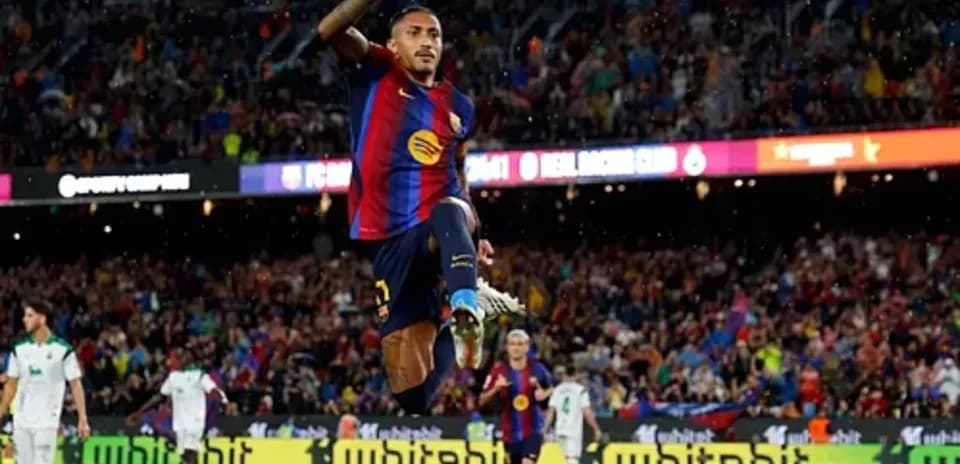 Player celebrating goal with fans at Camp Nou