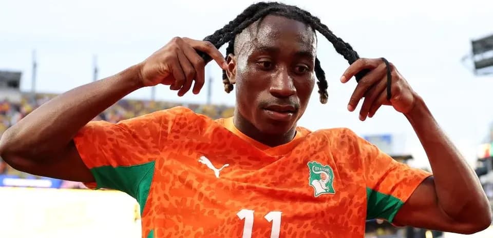 Player adjusting hair after match in orange jersey